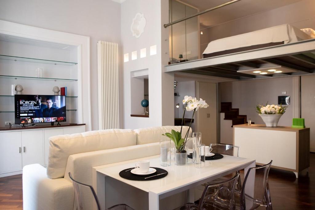 a living room with a white couch and a table at Portacatena Suite in Salerno