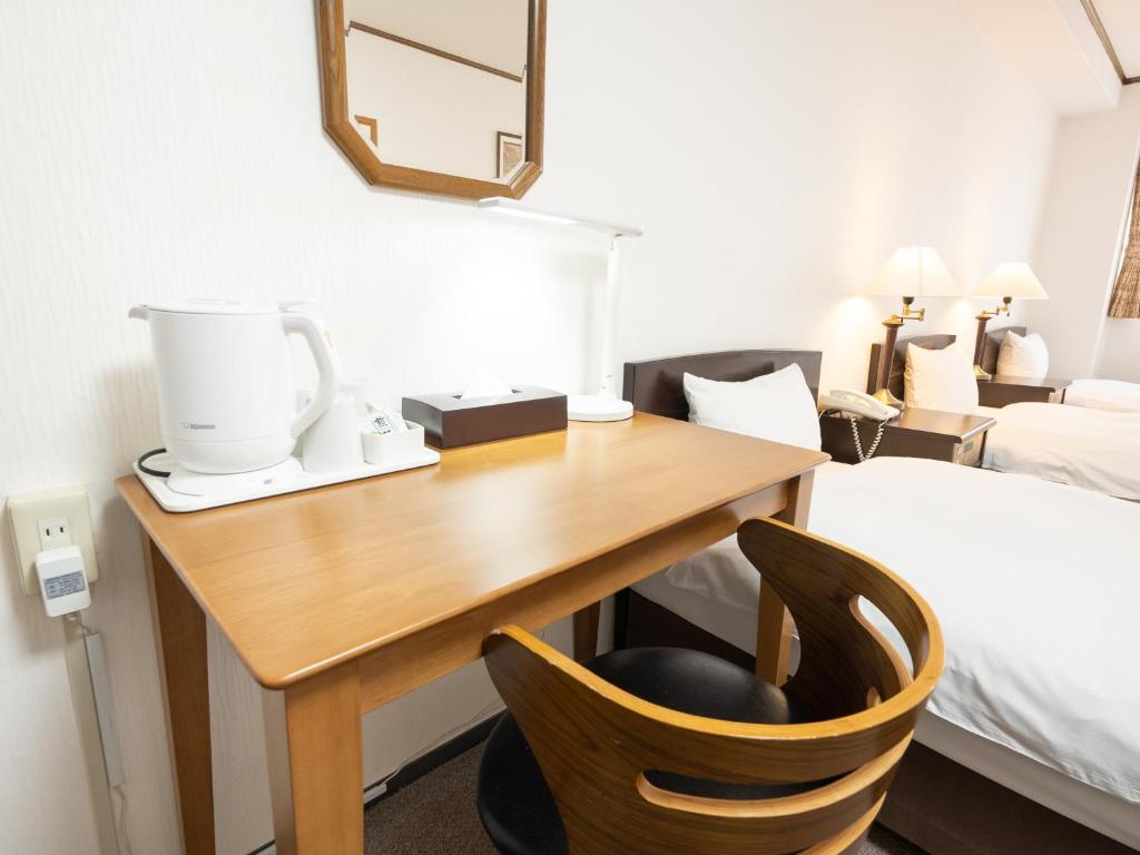 Postel nebo postele na pokoji v ubytování Tabist Hotel New Washington Shibuya