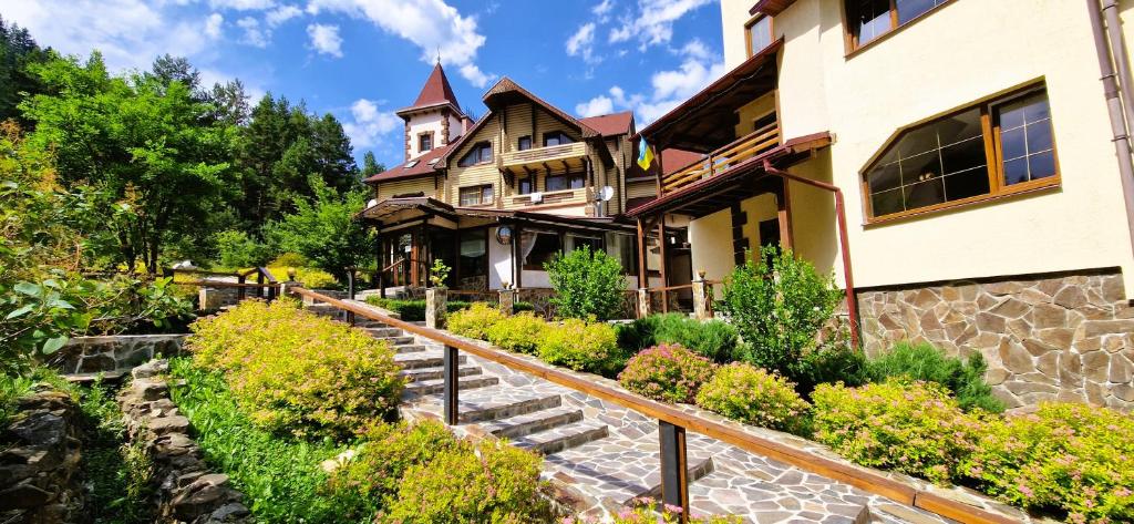 a house with a garden in front of it at Complex Hyzhky in Yaremche