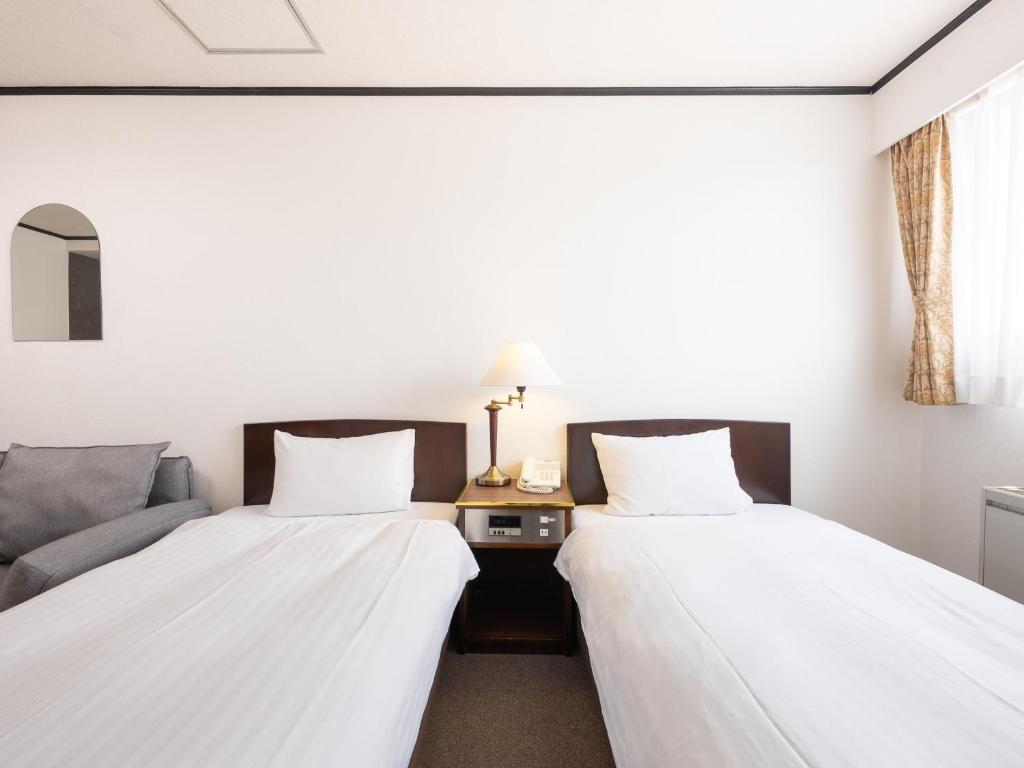Postel nebo postele na pokoji v ubytování Tabist Hotel New Washington Shibuya