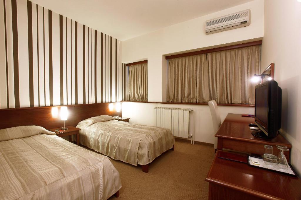Postel nebo postele na pokoji v ubytování Hotel Centar