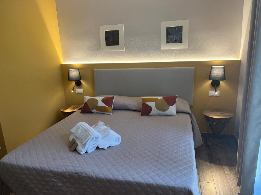 Postel nebo postele na pokoji v ubytování Hotel Il colle di Monterosso