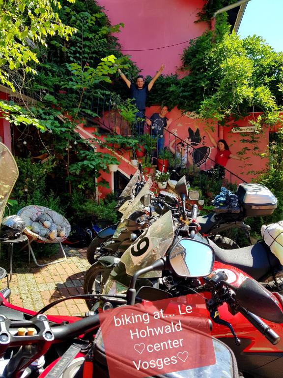 a man standing on a balcony next to a bunch of motorcycles at Tilly&#39;s B&amp;B and apartment house in Le Hohwald