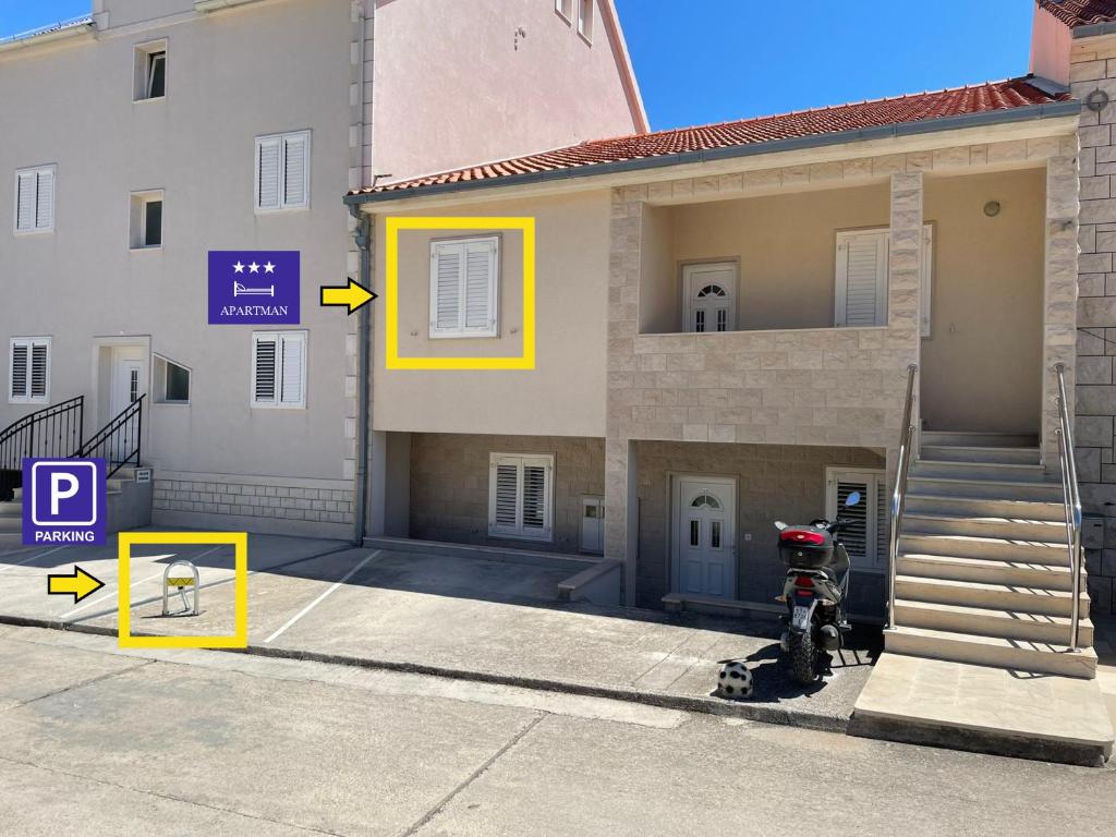 a building with a motorcycle parked in front of it at Apartman Ivo, Bol in Bol