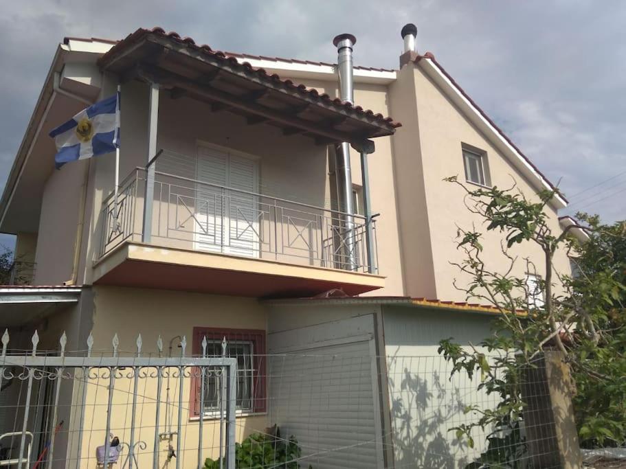 a house with a balcony and a fence at Grecos apartment in Preveza