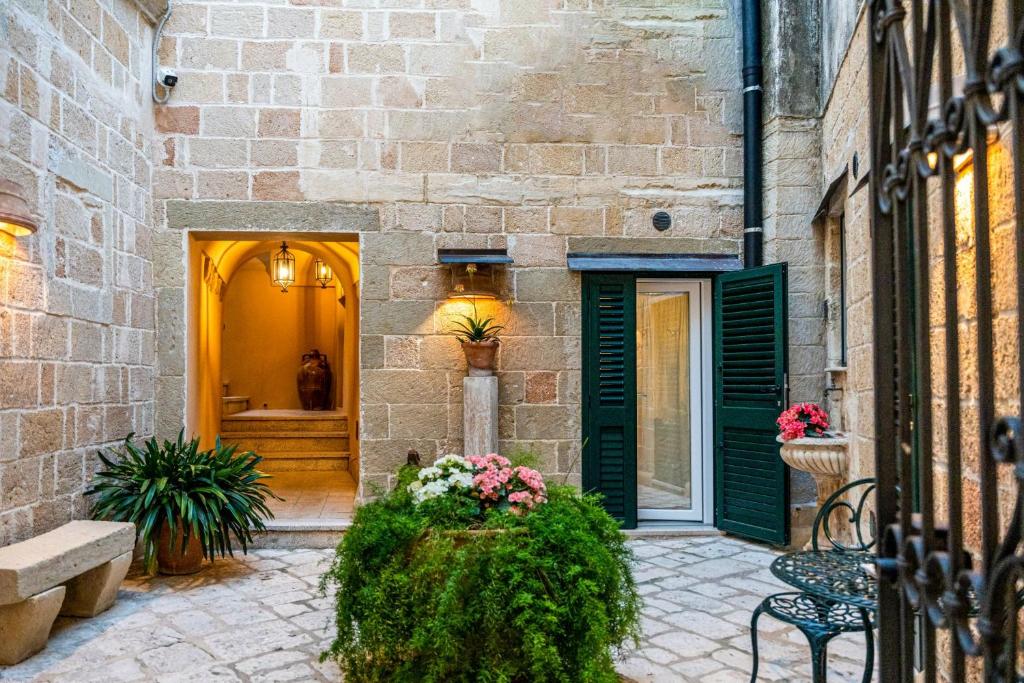 an entrance to a building with green doors and flowers at B&B Centro Storico in Otranto