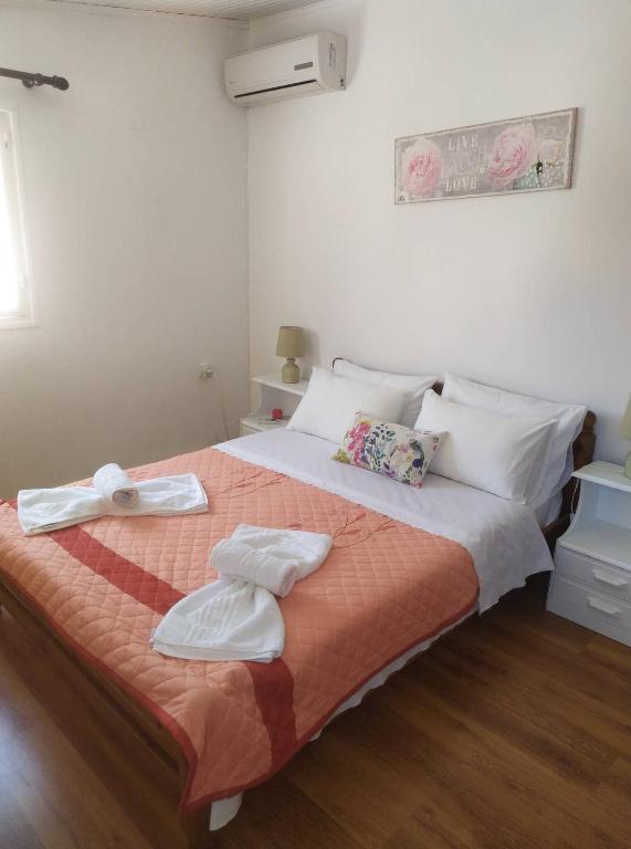 a bedroom with a large bed with towels on it at Eutyxia House in Gaios Walk to Center & Beaches in Gaios