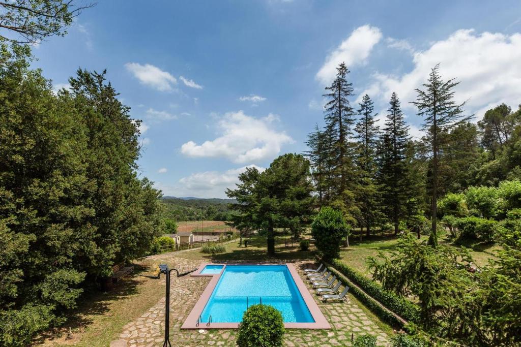 an overhead view of a swimming pool in a garden at L'aviador de Can Ton, in the middle of nature with its own stream in Sant Llorenc Savall