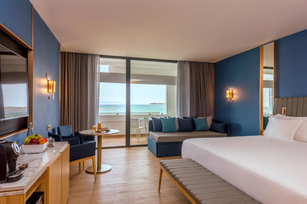 a hotel room with a bed and a living room at Barceló Tanger in Tangier