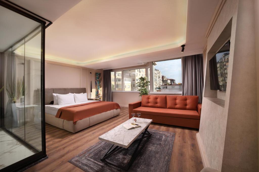 a hotel room with a bed and a couch at Harbiye Residence in Istanbul