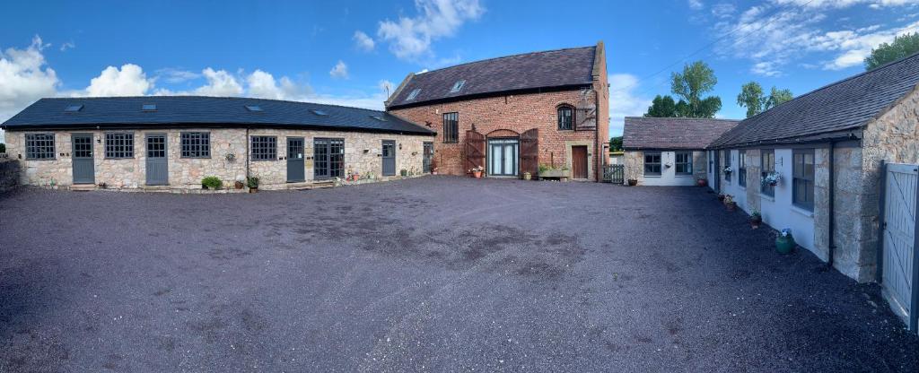 an empty parking lot in front of a brick building at Dwylig Isa Holiday Cottages in Rhuddlan