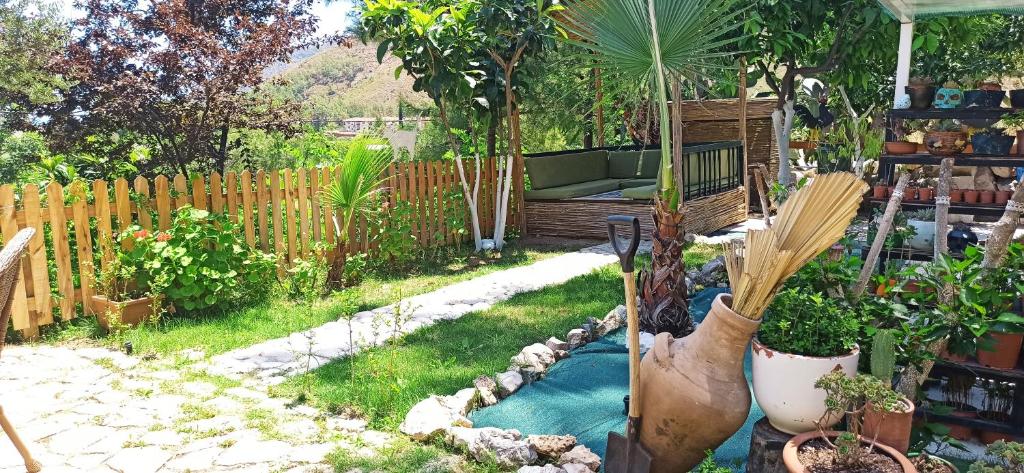 a garden with a pool of water in a yard at Swiss Eviniz Hotel in Adrasan