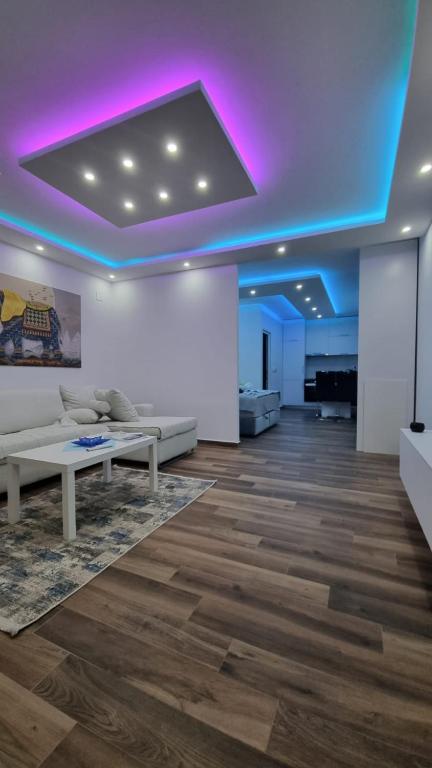 a living room with a couch and a purple ceiling at Coco apartments in Petrovac na Moru