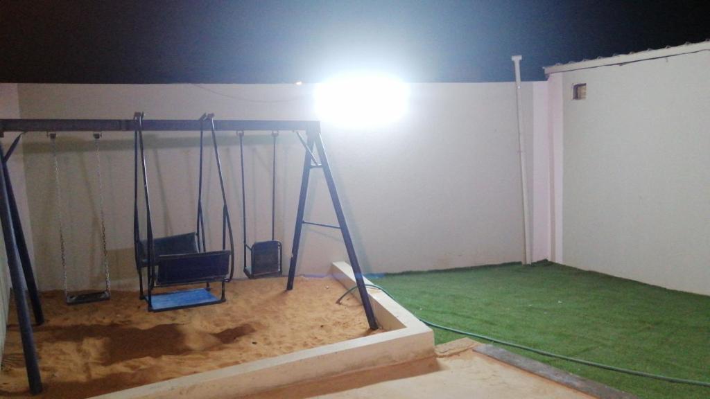 a room with a room with a light on the ceiling at استراحة سكنية للإيجار اليومي والشهري in Az Zulfi