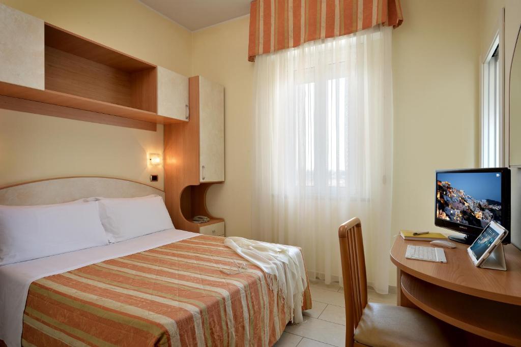 Łóżko lub łóżka w pokoju w obiekcie Hotel Elisir