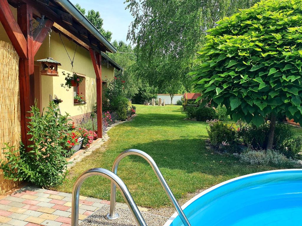 a swimming pool in a yard next to a house at Ubytování U Špačků Pálava in Novosedly