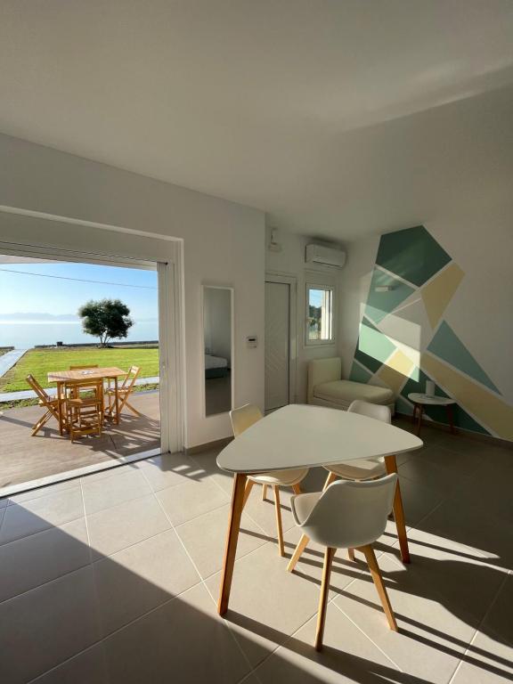 a living room with a table and chairs at Greek Dream Residence in Áyios Andréas Messinias