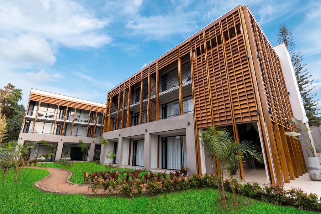 an external view of a building with a garden at Le Petit Village Boutique Hotel & Spa in Kampala