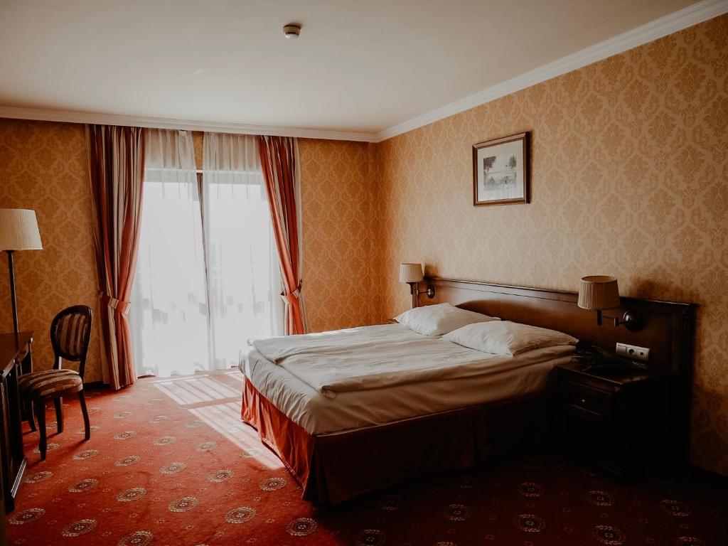 Postel nebo postele na pokoji v ubytování Hotel Delfin Spa&wellness