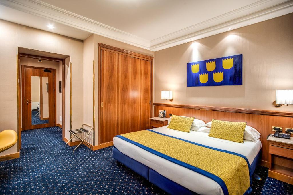 Postel nebo postele na pokoji v ubytování Hotel Diocleziano