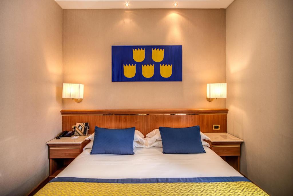 Postel nebo postele na pokoji v ubytování Hotel Diocleziano