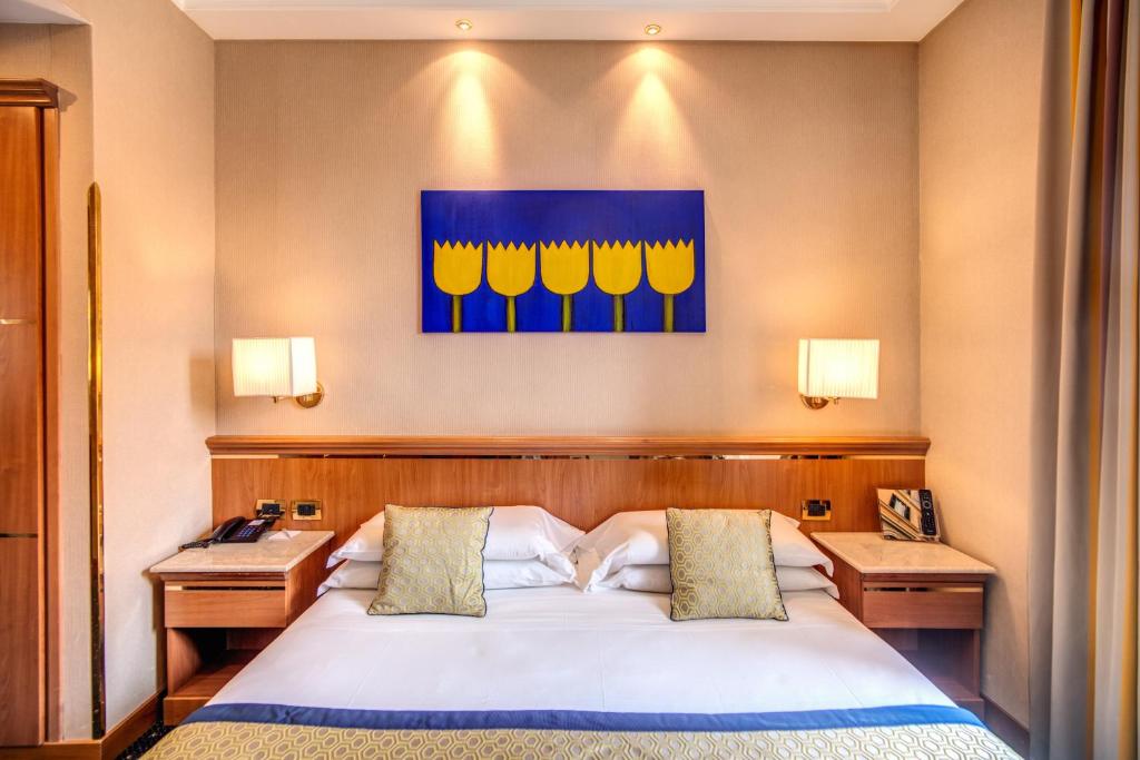 Postel nebo postele na pokoji v ubytování Hotel Diocleziano