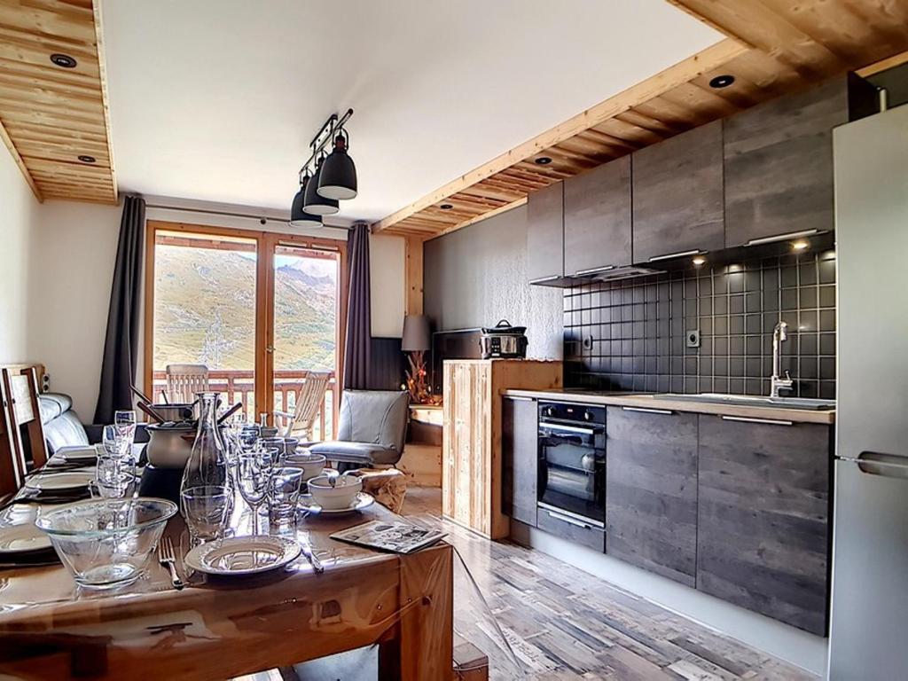 a kitchen with a wooden table with glasses on it at Appartement Les Menuires, 4 pièces, 10 personnes - FR-1-344-366 in Les Menuires
