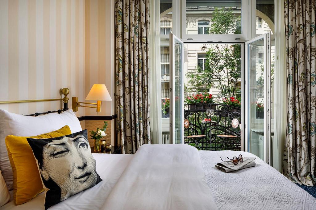 a bedroom with a bed with a face on the pillow at Opera Hotel Zürich in Zurich
