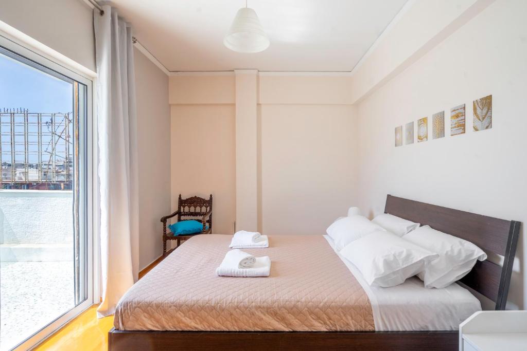 A bed or beds in a room at Penthouse in the heart of Athens / Koukaki area