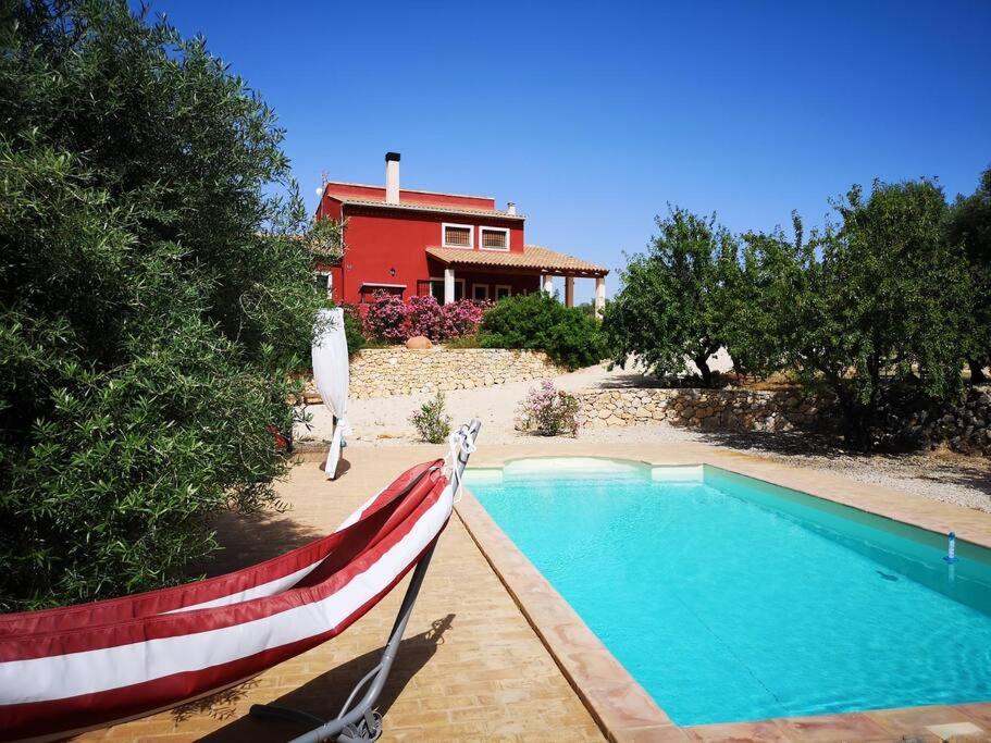 a house with a swimming pool in front of a house at Domicilio de Vida in Ricote