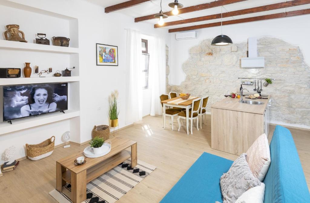 a living room with a couch and a table at Apartments Mario 2 in Pula