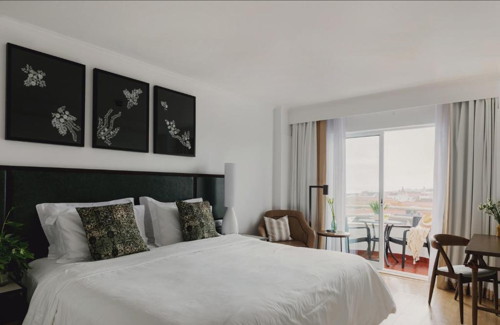 Postel nebo postele na pokoji v ubytování Hotel Ponta Delgada