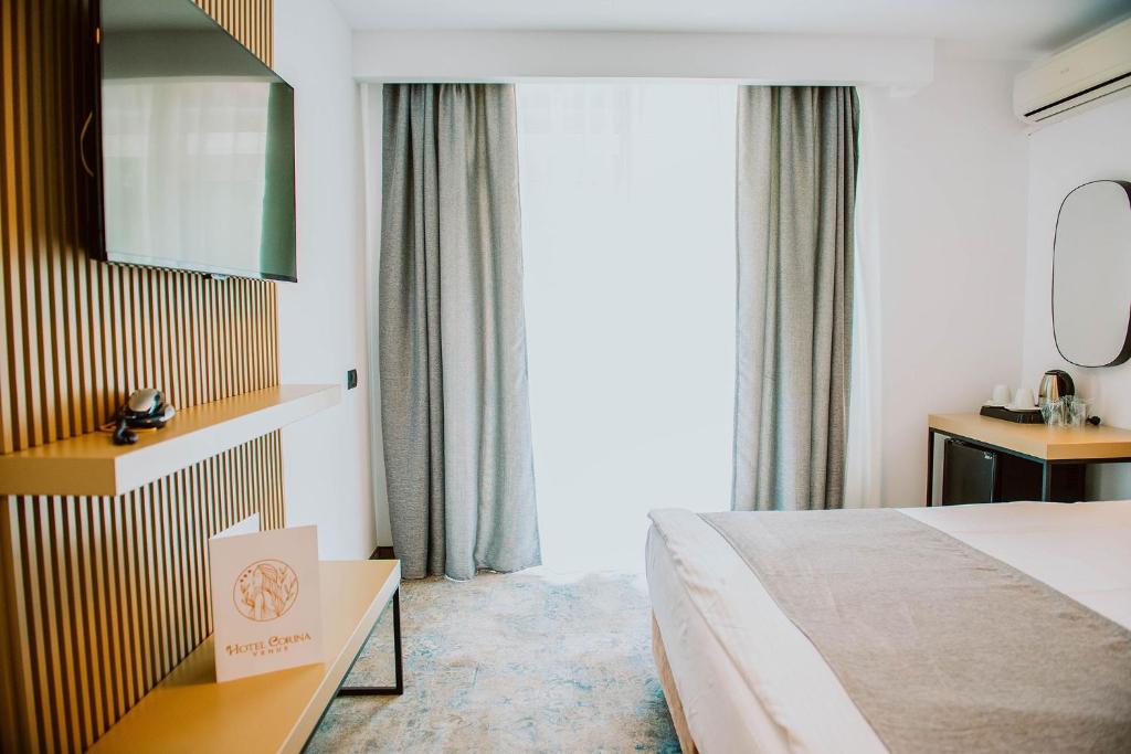 Postel nebo postele na pokoji v ubytování Hotel Corina