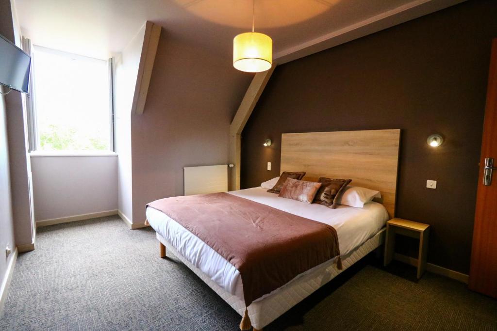 Postel nebo postele na pokoji v ubytování Hostellerie Bellevue