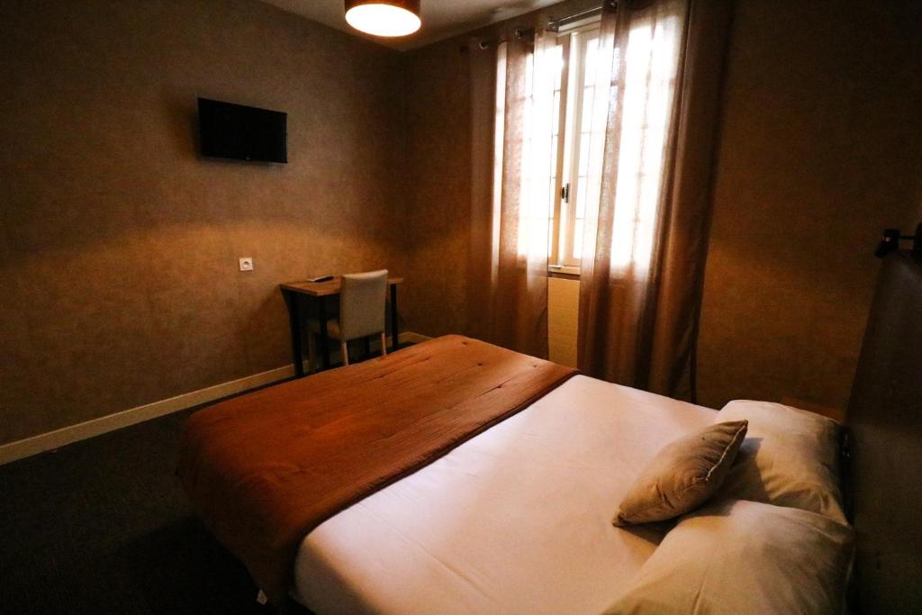 Postel nebo postele na pokoji v ubytování Hostellerie Bellevue