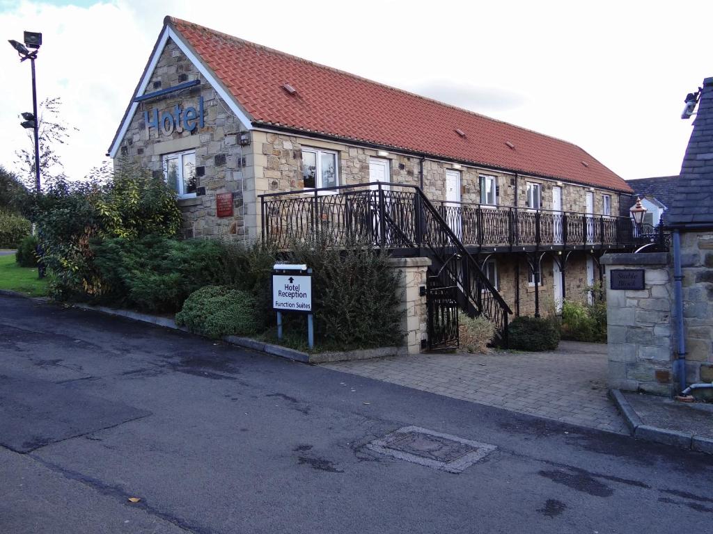 a large stone building with a sign in front of it at The Angel View Hotel in Gateshead