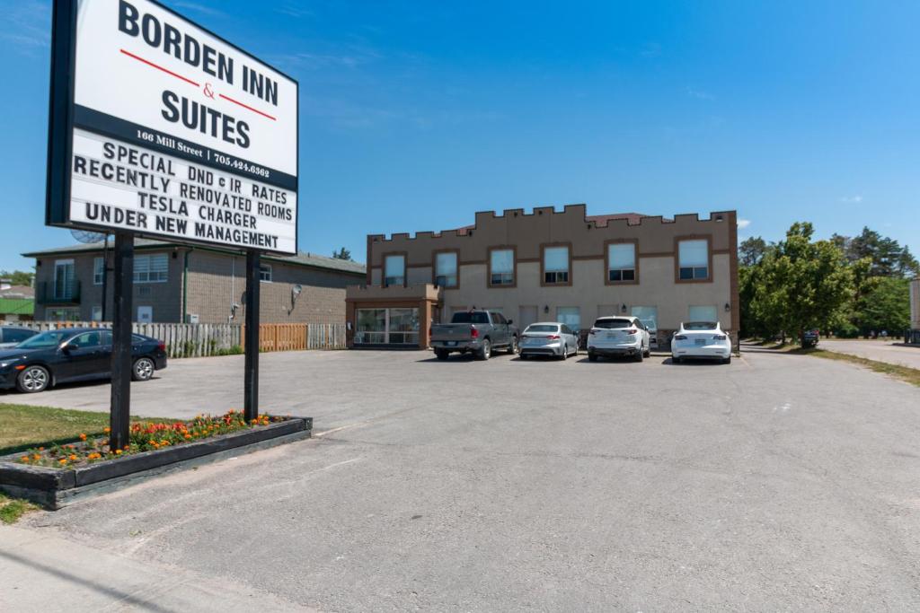 a parking lot with cars parked in front of a building at Borden Inn and Suites in Angus