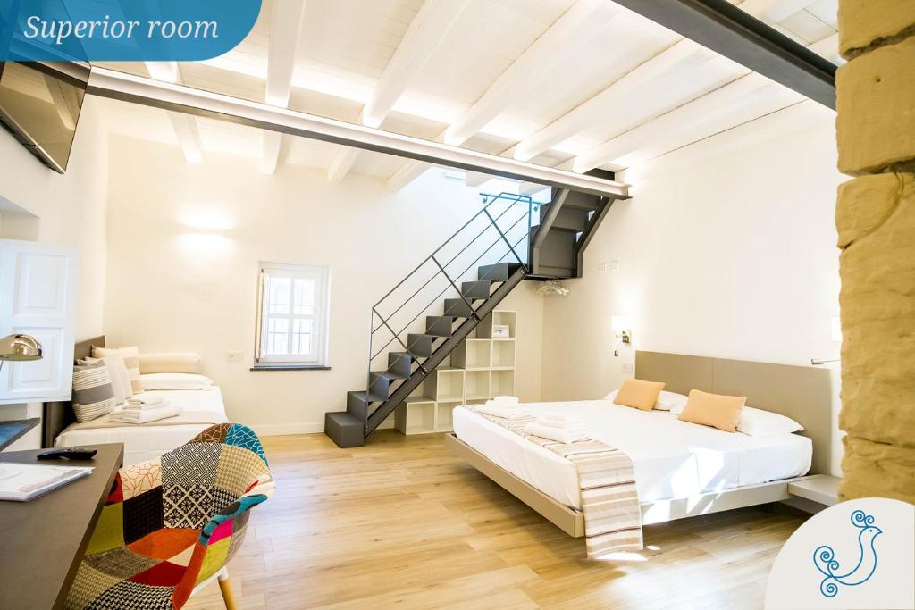 a loft bedroom with a bed and a staircase at Karú Suites in Cagliari