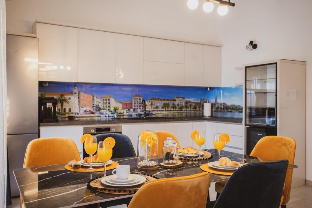 a kitchen with a dining room table and chairs at Luxury house Lucija in Dugi Rat