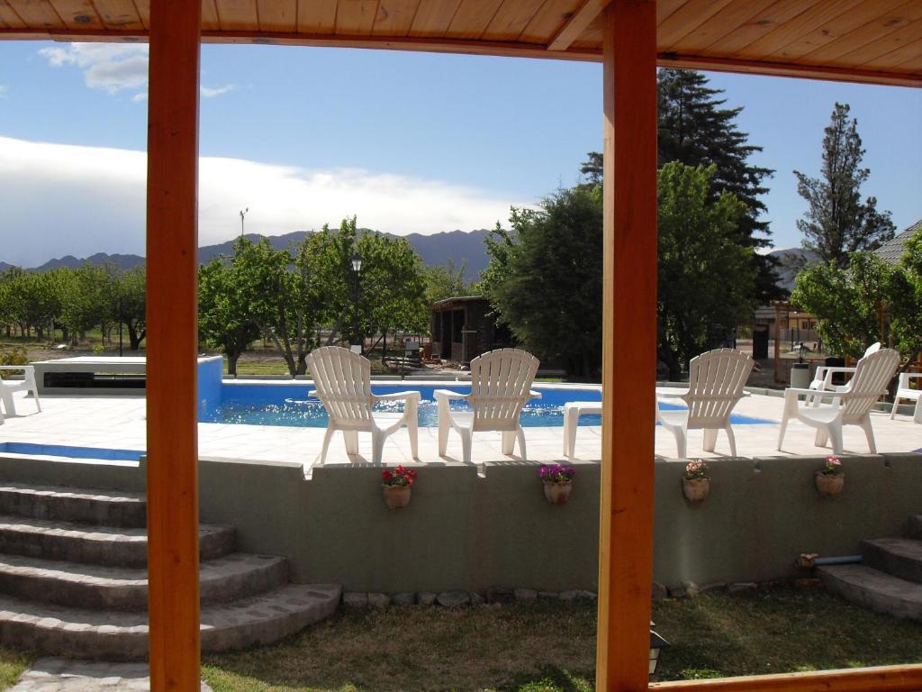 un patio con sillas y una piscina en Vistalba Lodge en Vistalba