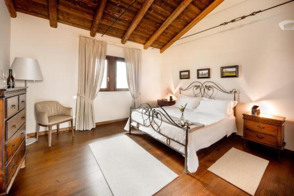 a bedroom with a bed and a desk and a chair at Orsone B&B in Gagliano