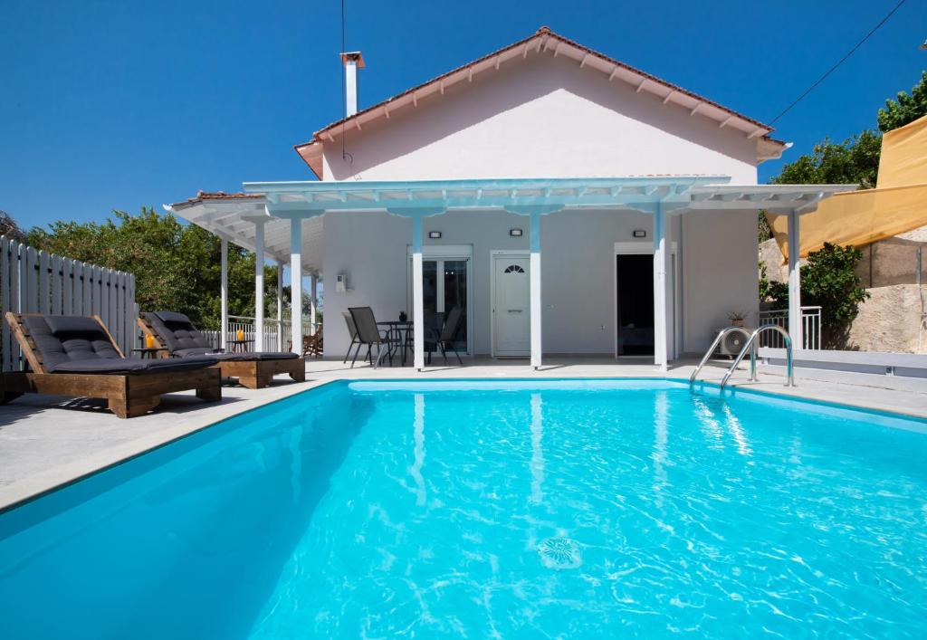 a villa with a swimming pool and a house at Beyond The Bridge in Sívros