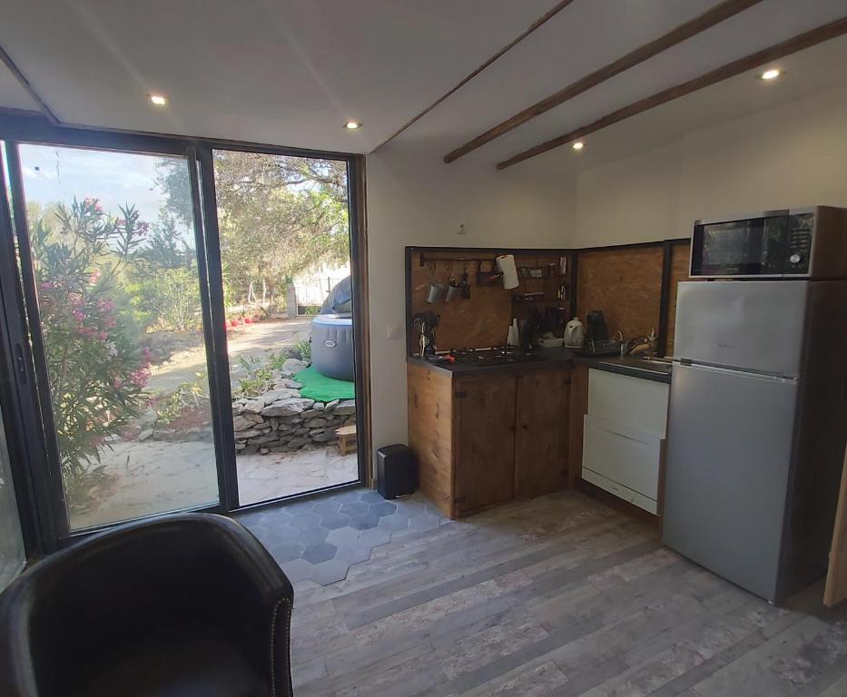 a kitchen with a white refrigerator and a window at In casa in Casta