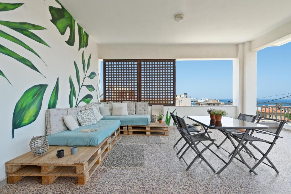 a living room with a couch and a table at Sea,City & Mountain View Apartment in Chania Town