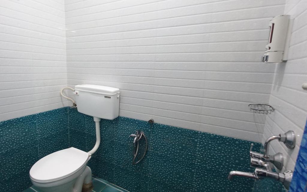 a small bathroom with a toilet and a shower at iSTAYS - Loop Road, Yercaud in Yercaud