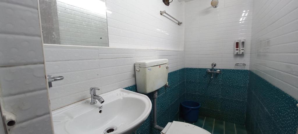 a bathroom with a sink and a toilet at iSTAYS - Loop Road, Yercaud in Yercaud