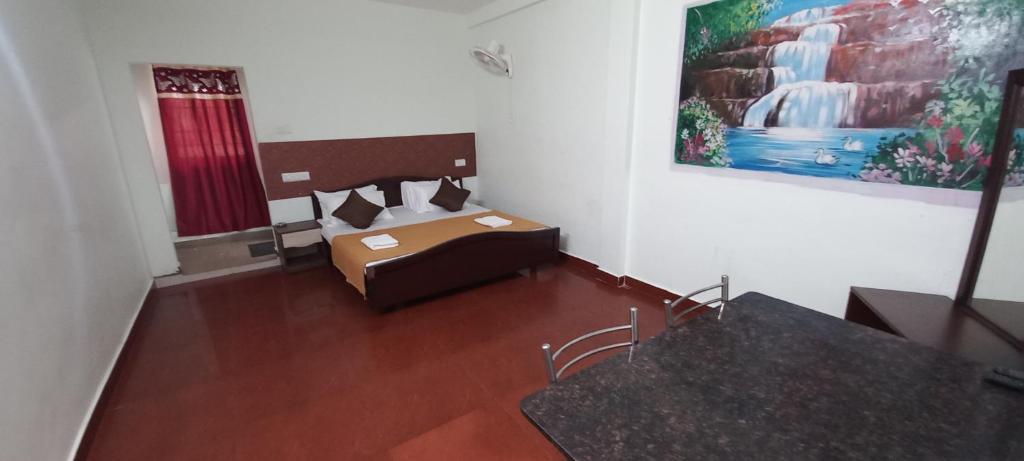 a room with a bed and a painting on the wall at iSTAYS - Loop Road, Yercaud in Yercaud