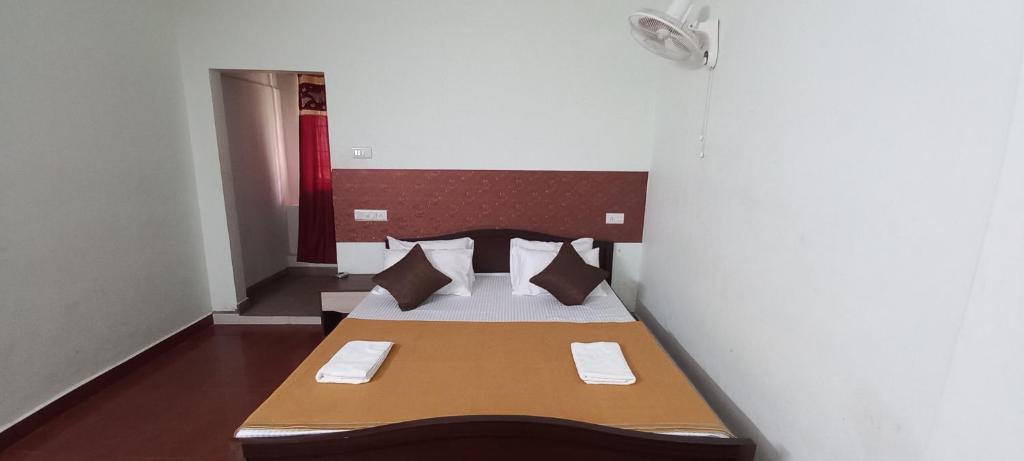 a small bedroom with a bed in a room at iSTAYS - Loop Road, Yercaud in Yercaud