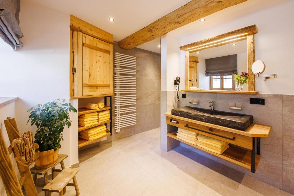 a bathroom with a sink and a mirror at Steinberger Hof Alm inkl. Chiemgau Karte in Ruhpolding