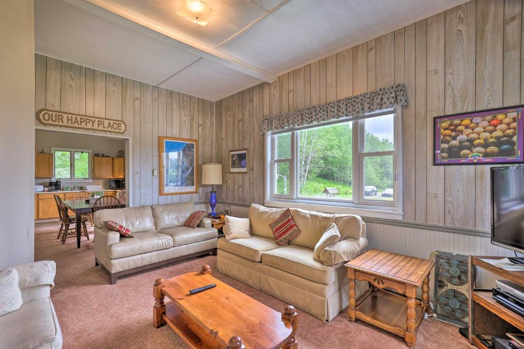 a living room with a couch and a table at Apartment with Shared Deck and View of Cowanesque Lake in Lawrenceville